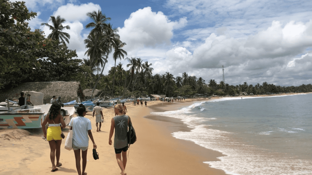People walking at Arugam Bay beach 