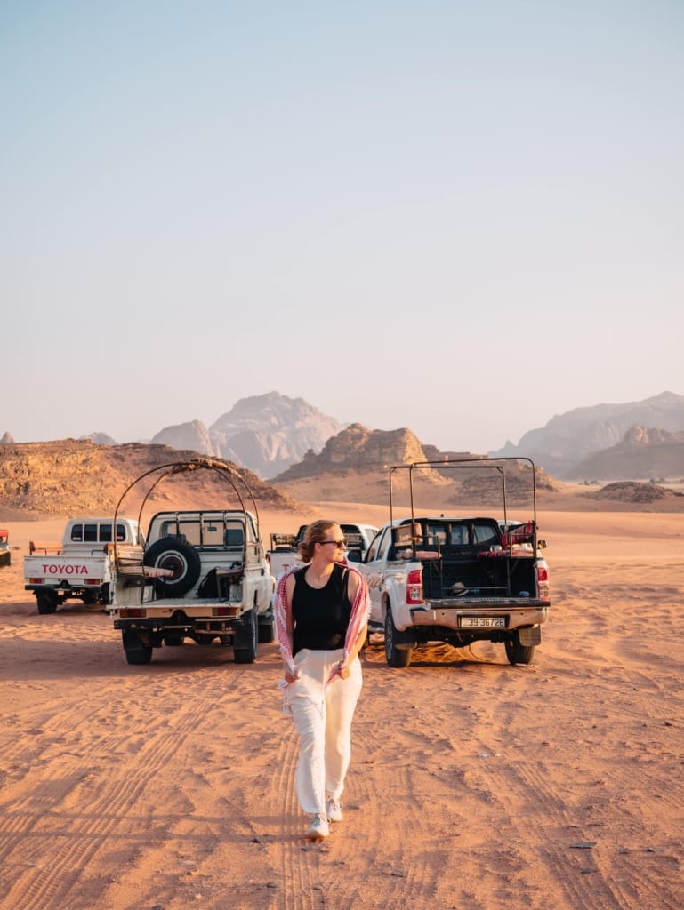 Alexandra Hayward (@findingalexx) posing by the safari at Wadi Rum, Jordan