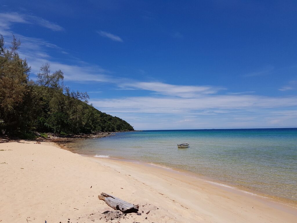 The beach at Koh Rong Samloem with a boat in the water