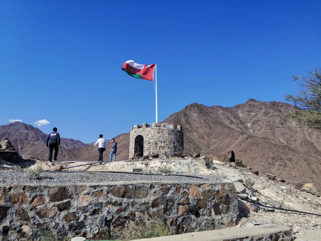 People walking near fort adjacent to Hiltop Restaurant Madha Oman
