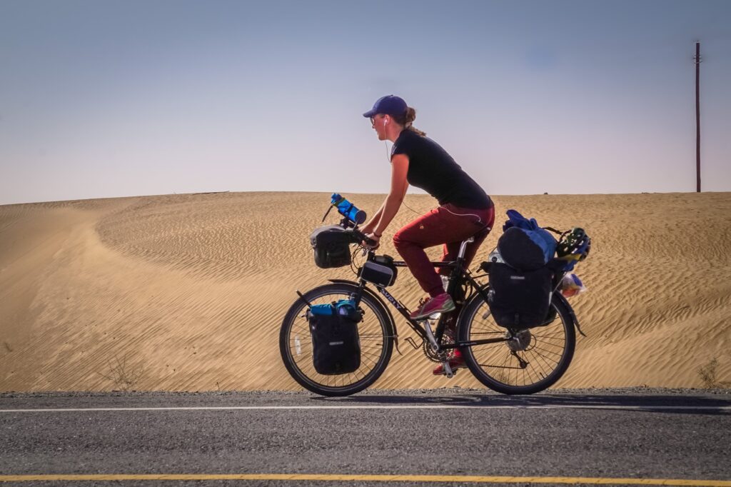 Fredrika Ek Biking with the desert behind her