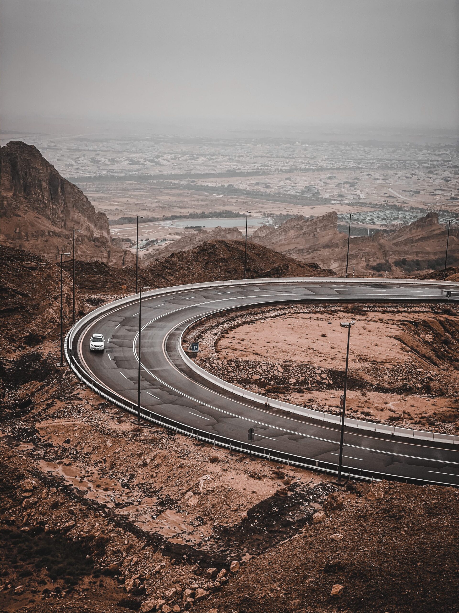 Curve Road on Jebal Hafeet Al Ain with an overview of the town in front