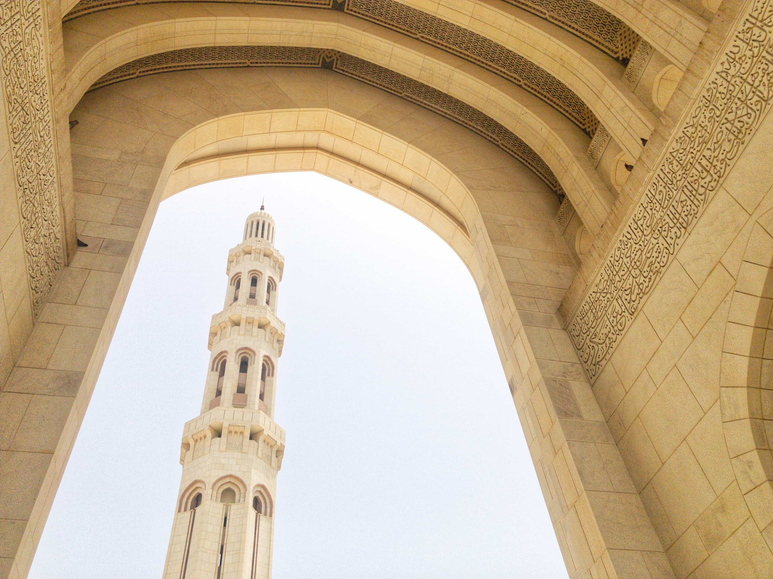 An Interior view of the Sultan Qaboos with a minaret seen across