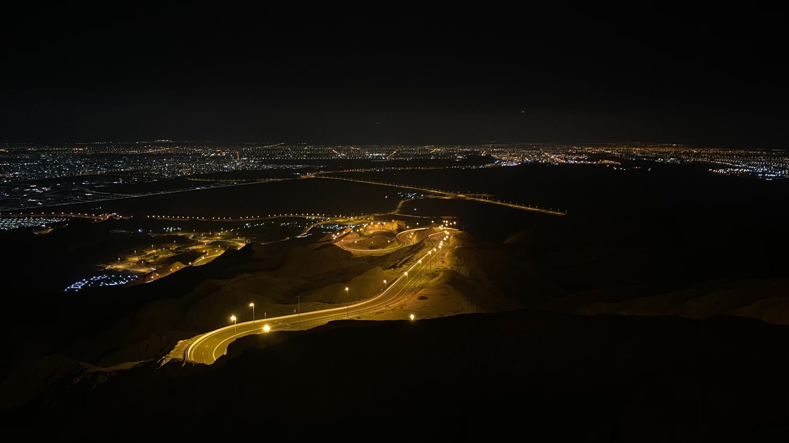 Dark scenes from Jebal Hafeet with a view of the light over the city